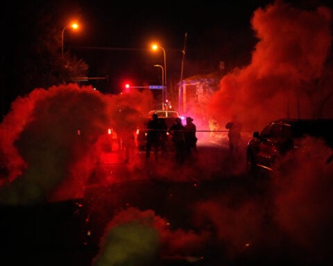 Tear gas floods a Minneapolis family's SUV after they get caught between protesters and officers