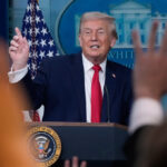 Trump recaps his first year back in office with winding remarks, paper tossing and impressions