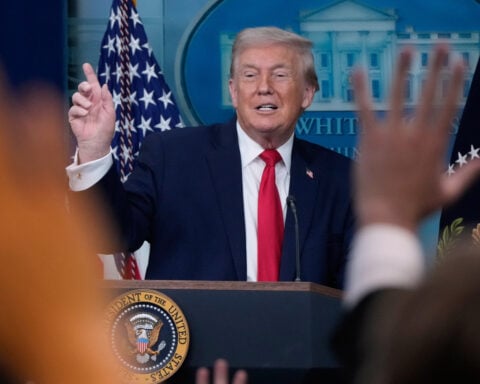 Trump recaps his first year back in office with winding remarks, paper tossing and impressions