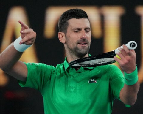 Novak Djokovic advances to Australian Open quarterfinals on a walkover after Jakub Mensik withdraws