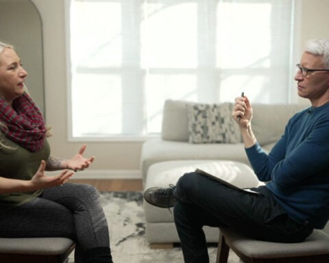 Exclusive: 'Pink coat lady' who recorded fatal encounter between federal officers and Alex Pretti speaks to Anderson Cooper