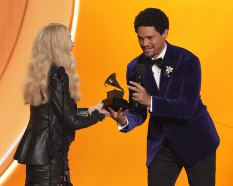 A smiling Cher laughs at her Grammys flubs in a good-natured, chaotic appearance