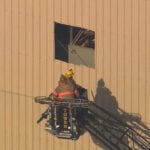 Crews free worker trapped in elevated sand hopper