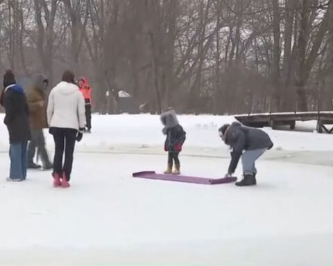 Men create carousel on frozen pond