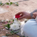 Grieving Iranians cowed into silence beside the graves of protesters