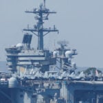 US carrier shoots down Iranian drone and armed boats threaten US tanker as tensions with Iran escalate
