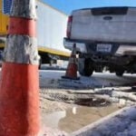 Mystery manhole leak creating an icy hazard for food wholesaler