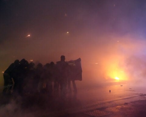 Italian police fire tear gas as protesters clash near Winter Olympics hockey venue