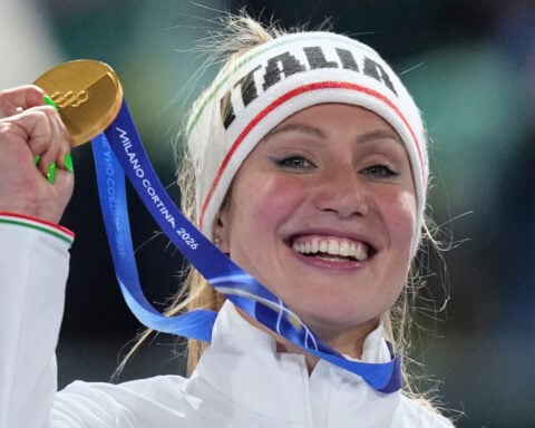 Francesca Lollobrigida hugs her son after winning Italy's first gold of the Milan Olympics