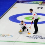 On the ice, these curlers are scowling at each other. Off the ice, they're happily married