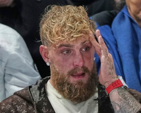 Jake Paul cheers from the second row as his fiancée, Jutta Leerdam, wins Olympic speedskating gold