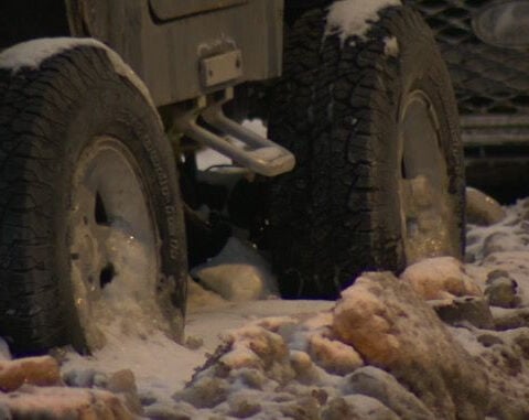 Ongoing water main break turns Cleveland street into ice, stranding cars
