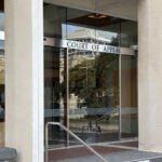 Mosque gunman wanted online fame. A muted court hearing shows how New Zealand has tried to curb that