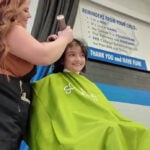 Community shaves heads, raises $20,000 for childhood cancer research