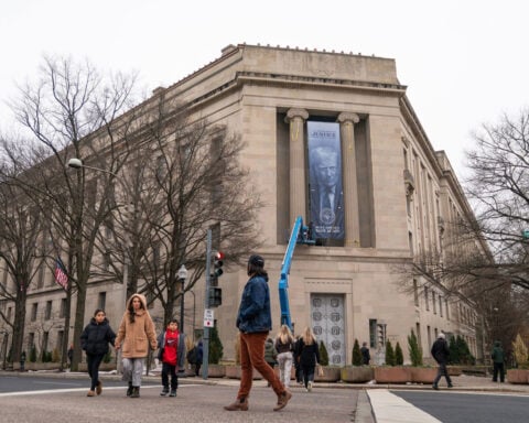 Giant banner of Donald Trump hung at Justice Department headquarters