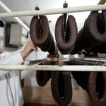 A traditional sausage in the shape of a horseshoe is 'ironed' for dryness in southeastern Serbia