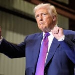 The Latest: Trump's entourage stocked with people who promoted election loss falsehoods