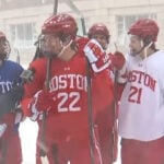 Boston University hockey team walks to practice in full uniform during blizzard