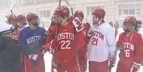 Boston University hockey team walks to practice in full uniform during blizzard