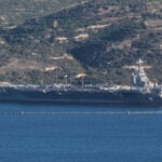 Protest held on Greek island against docked US aircraft carrier as Iran tension builds