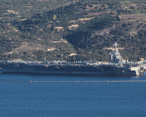 Protest held on Greek island against docked US aircraft carrier as Iran tension builds
