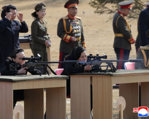 North Korea’s Kim gifts rifles to officials and his daughter takes aim after party congress