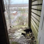 House on the verge of falling down a hill