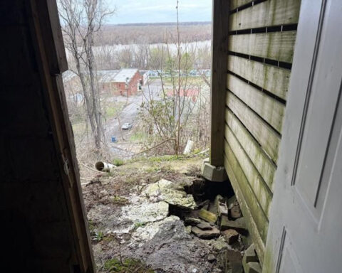 House on the verge of falling down a hill