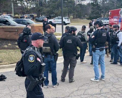 The Latest: Man fatally shot attacking Michigan synagogue, AP source says