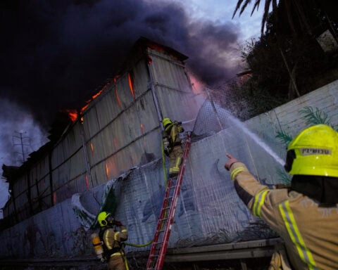 The Latest: Airstrike pounds Iran near pro-government rally as war threatens global economy