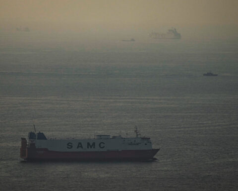 The Latest: Iran retaliates against Gulf energy sites as stocks sink worldwide