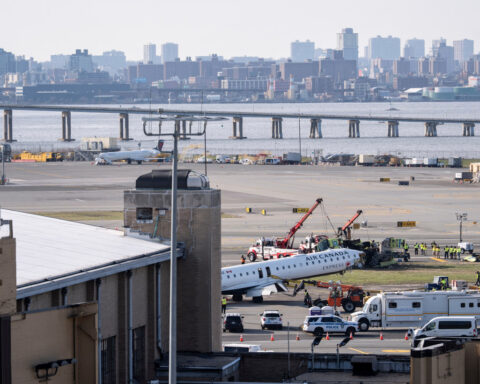 Mangled plane in LaGuardia crash is towed from runway as most injured passengers leave hospital