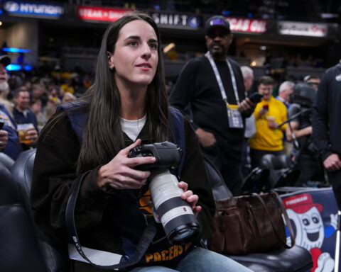 Caitlin Clark works as a photographer for the Indiana Pacers as they host LeBron and the Lakers