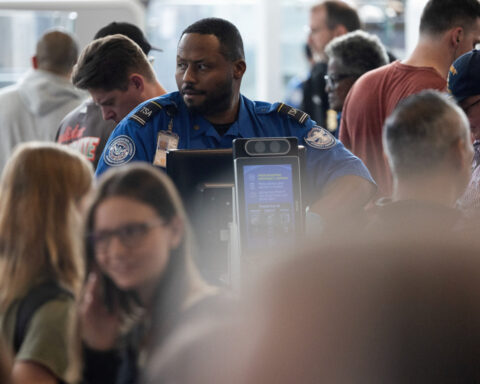 ICE agents take a more active role in airport security, but long lines persist ahead of the weekend traveler rush