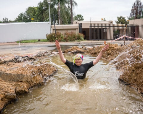 A South African politician goes snorkeling in a giant pothole to highlight city management failures