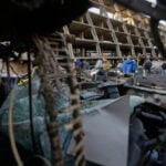 Iran hits Kuwait airport and a tanker off Qatar while strikes batter Tehran ahead of Trump speech