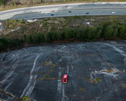 Car shell suspended on rock face above British Columbia highway in apparent prank