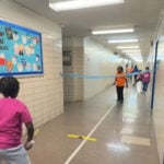 Students learning to play tennis without a court