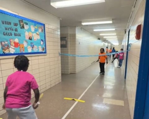 Students learning to play tennis without a court