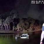 Elderly man and woman rescued from partially submerged car