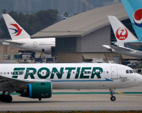 Close call at LAX: Frontier Airlines jet slams on the brakes when two trucks cross its path