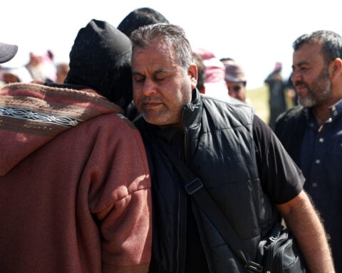 A Syrian man buries his wife and 4 children killed in Israeli strikes on Beirut