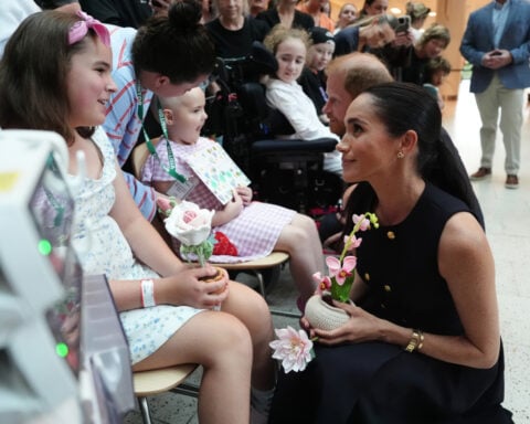 Prince Harry and Meghan arrive in Australia for a low-key, privately funded visit