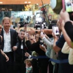 Prince Harry and Meghan arrive in Australia for a low-key, privately funded visit