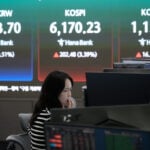 Asian shares mostly rise after Wall Street rallies on lower oil prices