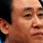 China Evergrande's billionaire boss falls from circles of power to fraud plea