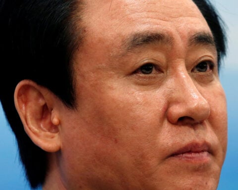 China Evergrande's billionaire boss falls from circles of power to fraud plea