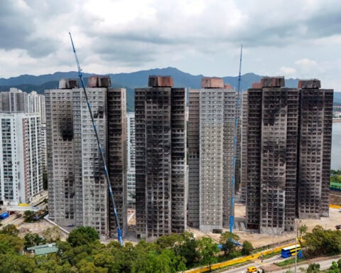 Robotic legs help elderly Hong Kong fire survivors climb back for belongings