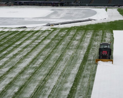 A mid-April snowstorm coats Coors Field as Dodgers-Rockies series gets off to frosty start