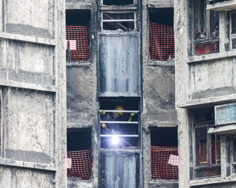 Hong Kong fire victims scour scorched homes for keepsakes